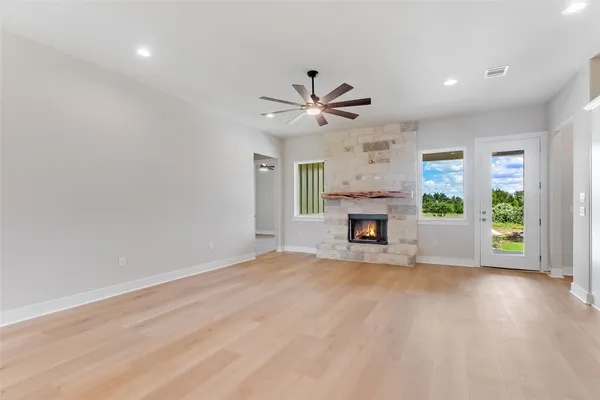 a view of a livingroom with a fireplace and window