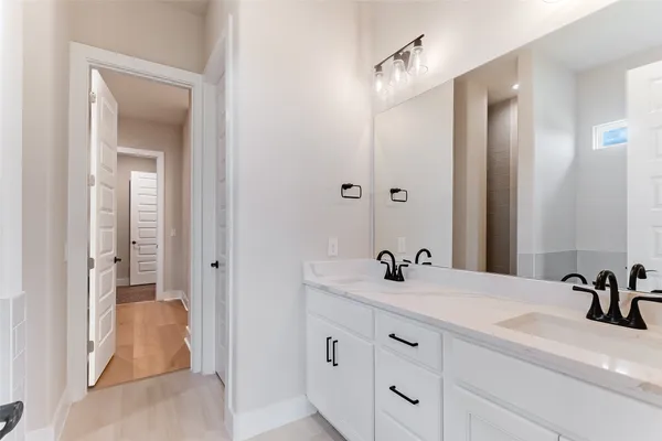 a bathroom with a double vanity sink and mirror