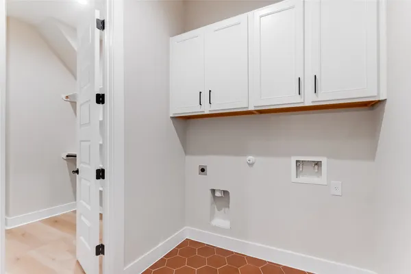 a view of a closet with white walls