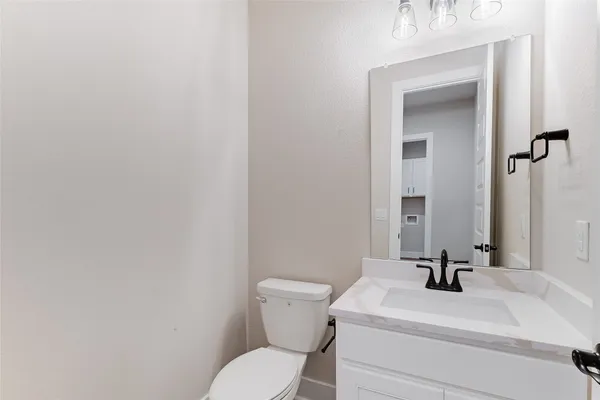 a bathroom with a sink a toilet and mirror