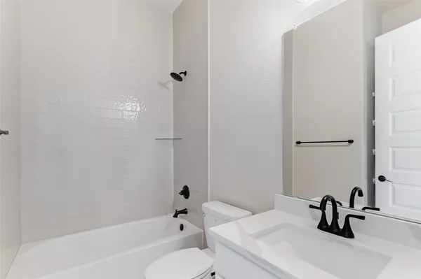 a bathroom with a sink a toilet and a bathtub