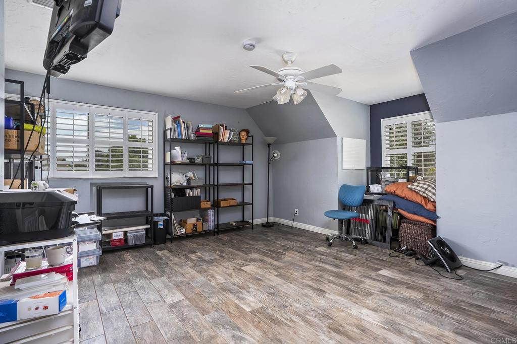 2430 Geyer Lane Alpine, CA 91901 - Photo 26 of 60 a living room with furniture a flat screen tv and a book shelf