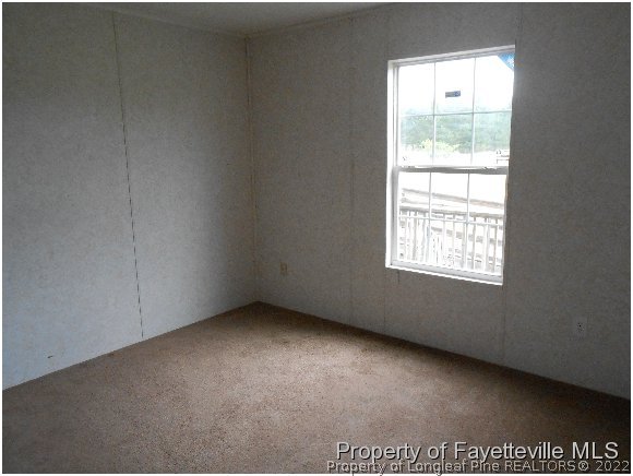 1591 Loop Road Raeford, NC 28376 - Photo 8 of 10 an empty room with a window