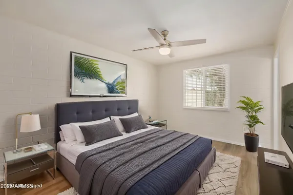 a bedroom with bed and a window