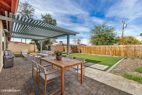 a view of a patio with a table and chairs