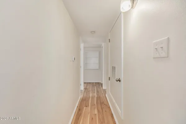 a view of a hallway with wooden floor
