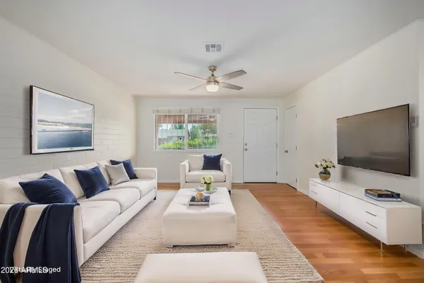 a living room with furniture and a flat screen tv