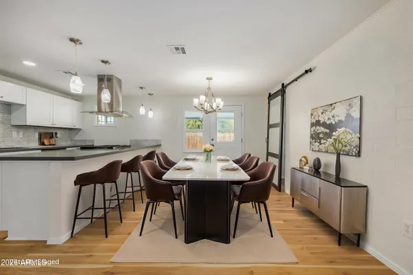 a view of a dining room with furniture and wooden floor