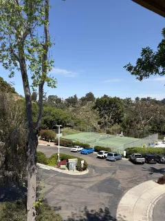 a view of a road with cars parked