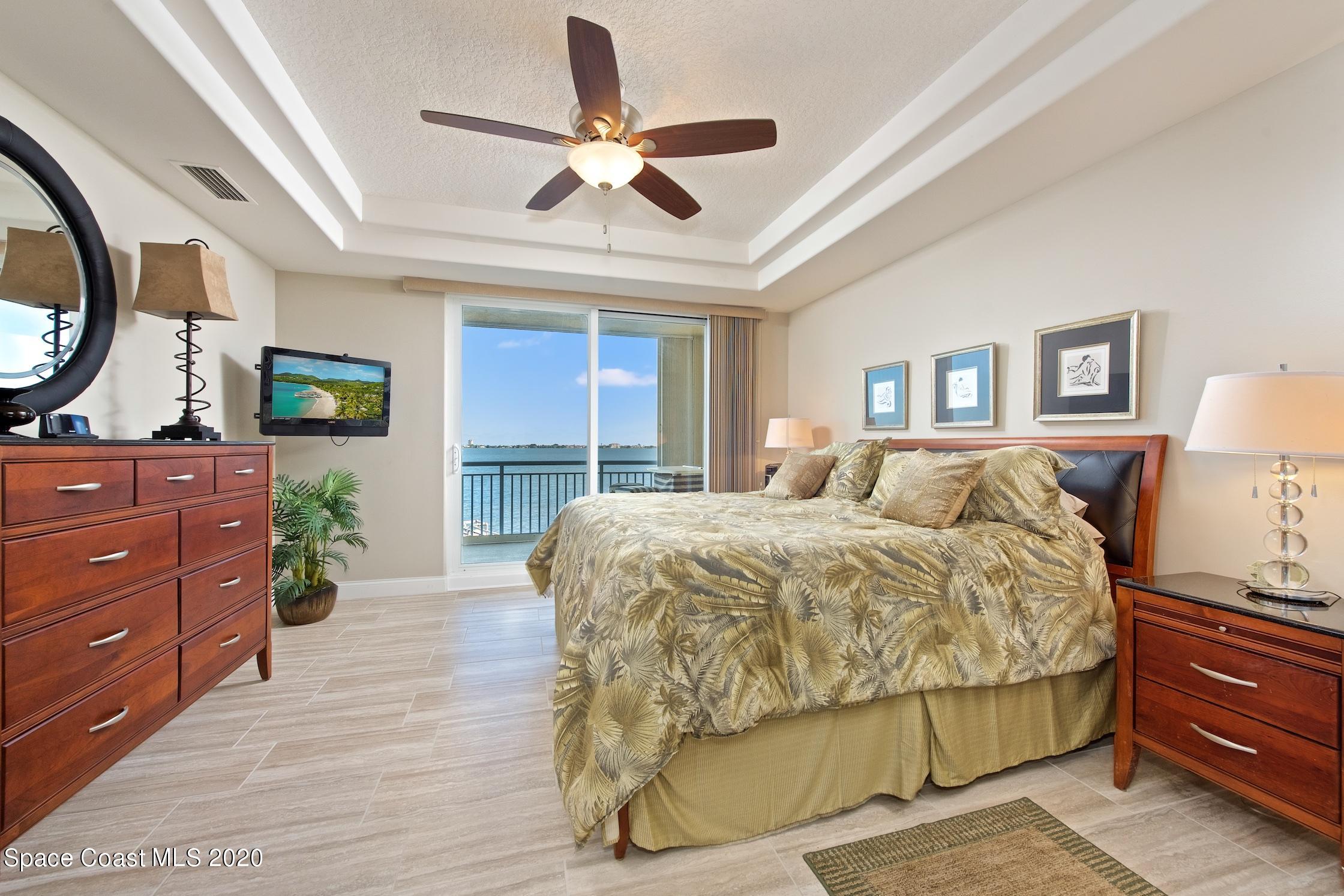 4955 Dixie Highway Northeast, Unit 404 Palm Bay, FL 32905 - Photo 16 of 50 a spacious bedroom with a bed and a dresser