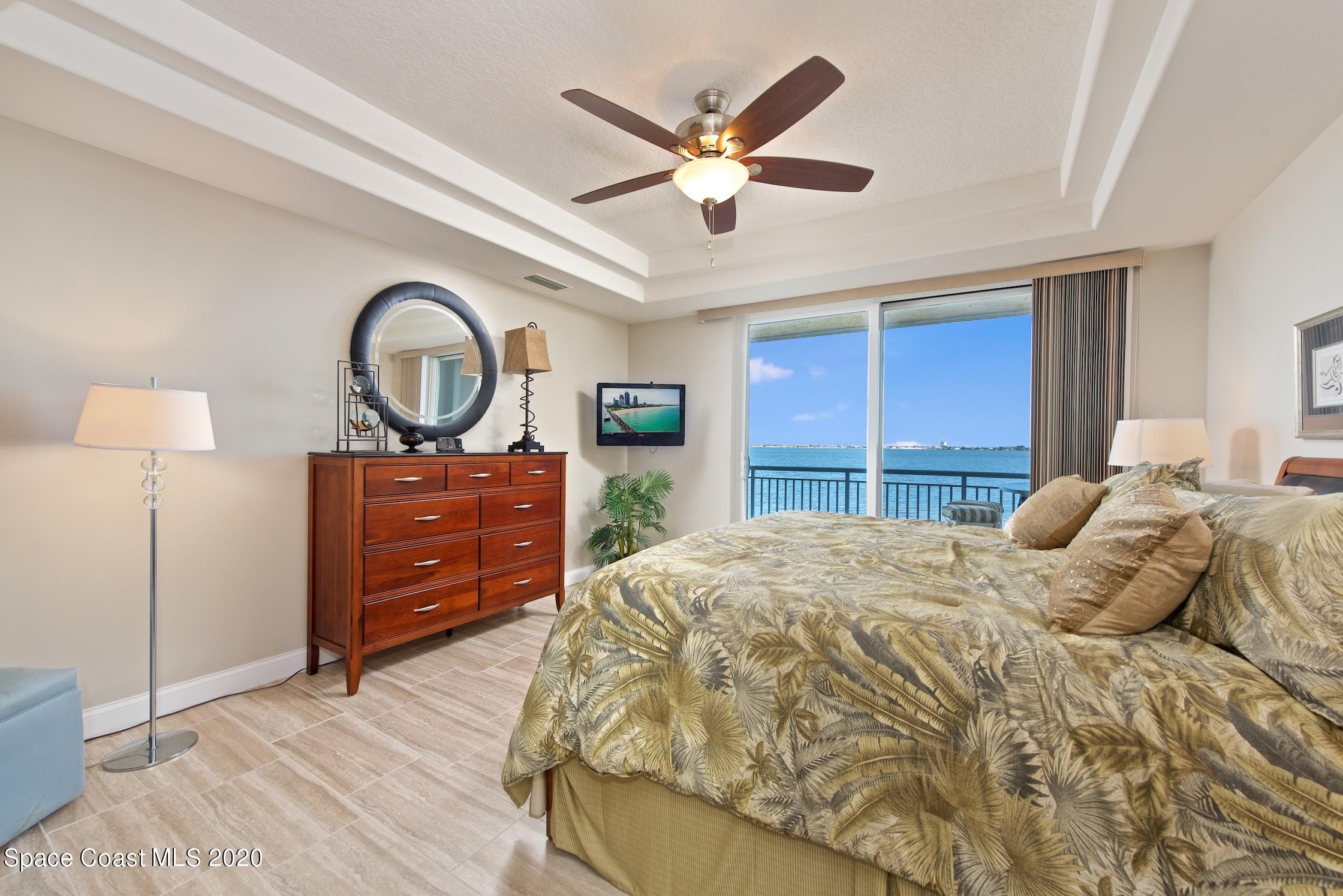 4955 Dixie Highway Northeast, Unit 404 Palm Bay, FL 32905 - Photo 17 of 50 a bedroom with a bed and a chandelier