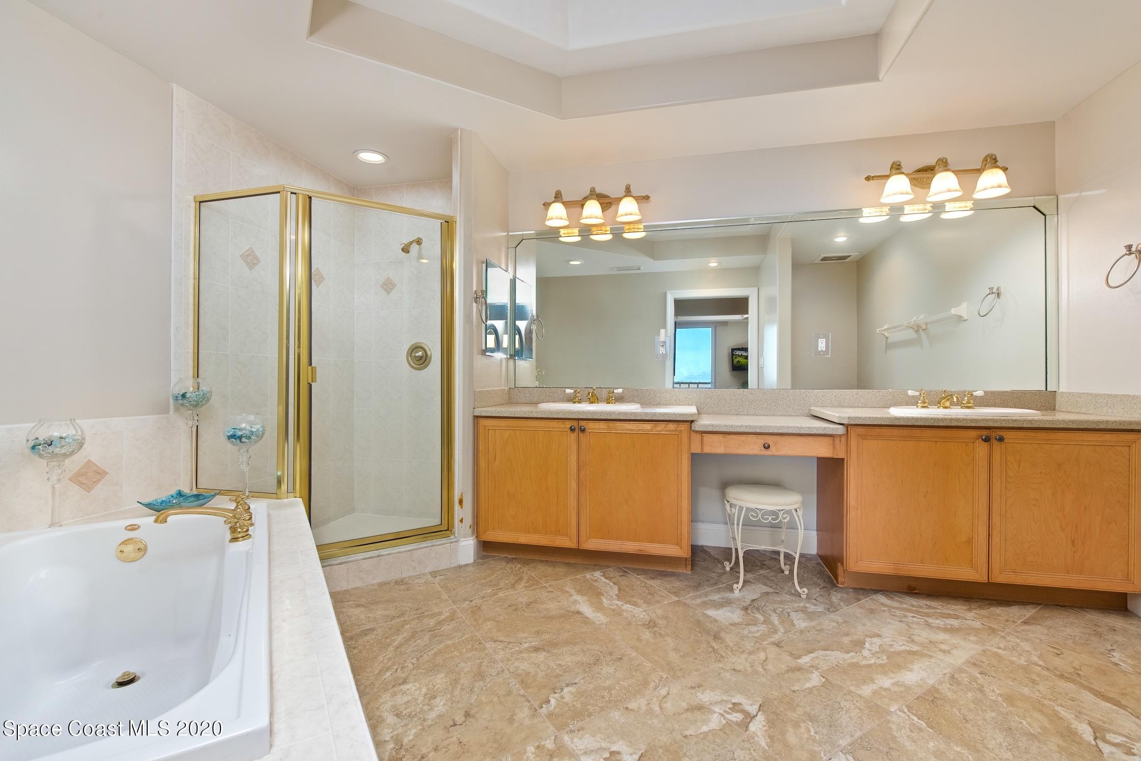 4955 Dixie Highway Northeast, Unit 404 Palm Bay, FL 32905 - Photo 19 of 50 a bathroom with a sink a large mirror and a bathtub
