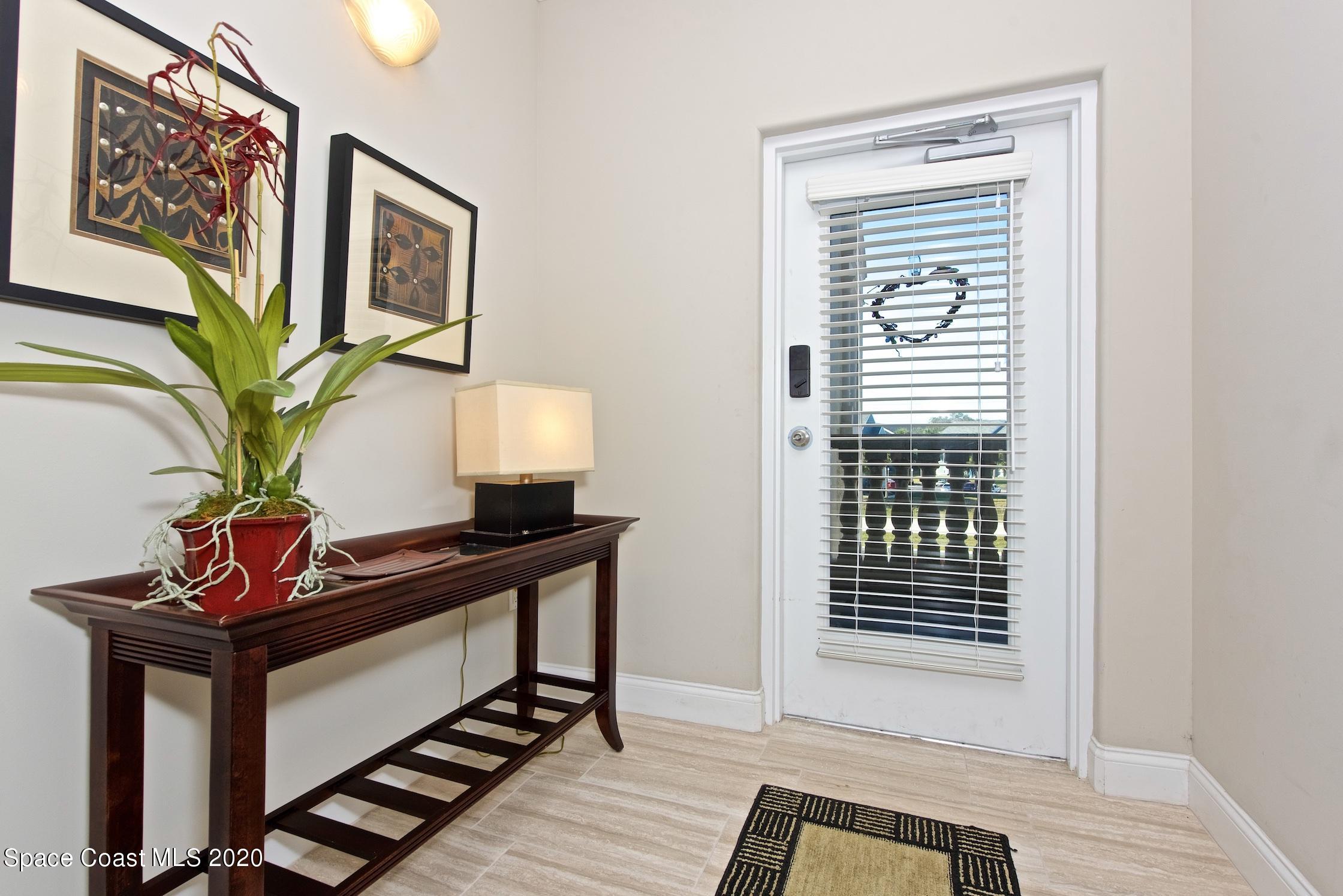4955 Dixie Highway Northeast, Unit 404 Palm Bay, FL 32905 - Photo 3 of 50 a living room with furniture and a window
