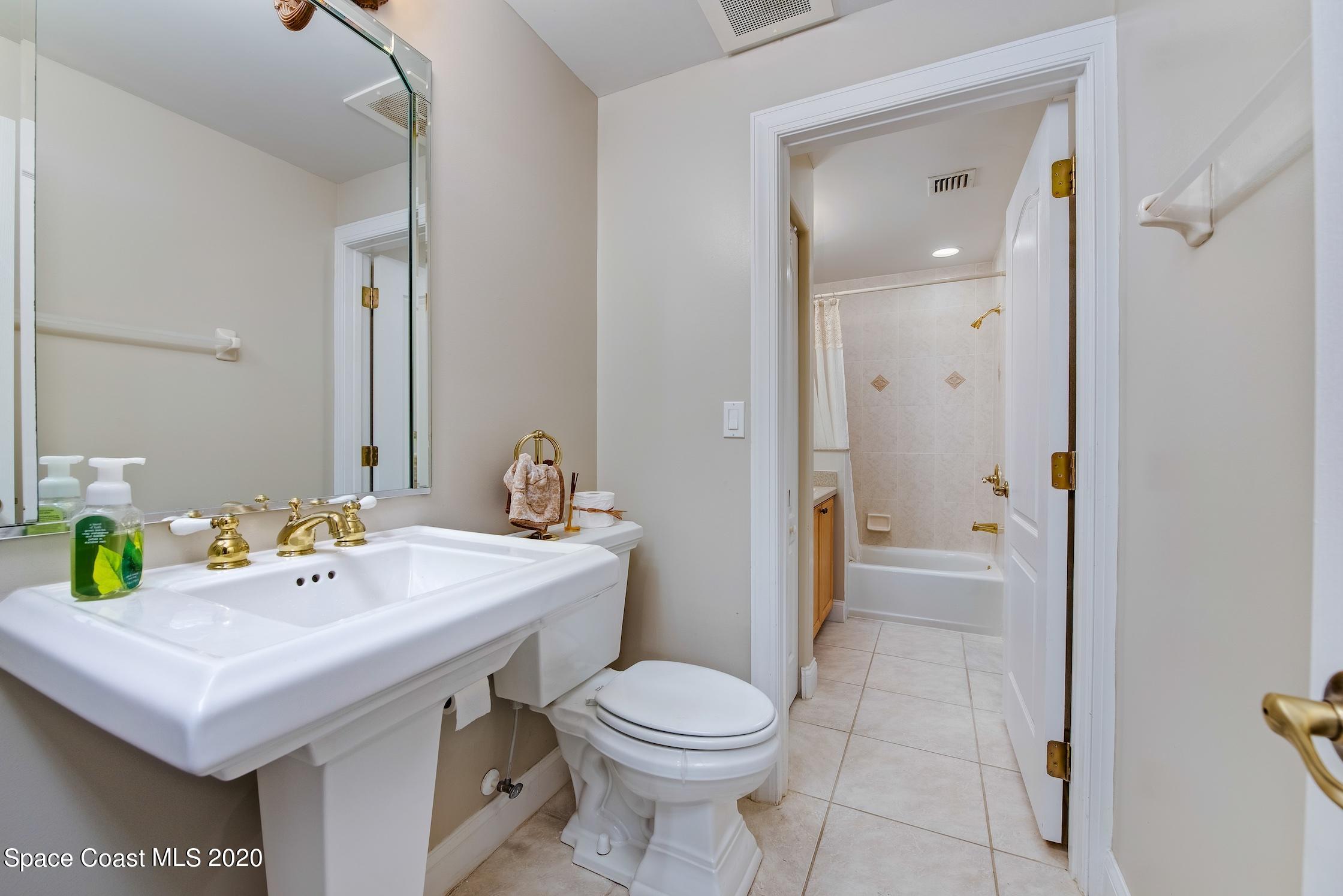 4955 Dixie Highway Northeast, Unit 404 Palm Bay, FL 32905 - Photo 24 of 50 a bathroom with a sink a toilet and shower