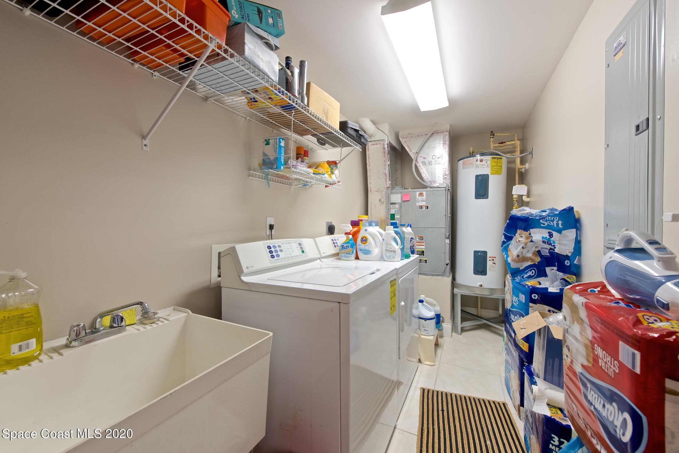 4955 Dixie Highway Northeast, Unit 404 Palm Bay, FL 32905 - Photo 26 of 50 a storage room with a washer and dryer