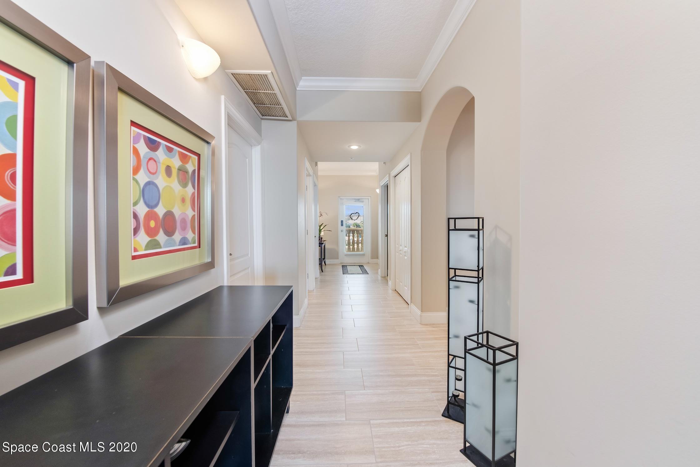 4955 Dixie Highway Northeast, Unit 404 Palm Bay, FL 32905 - Photo 4 of 50 a hallway with wooden floor and windows