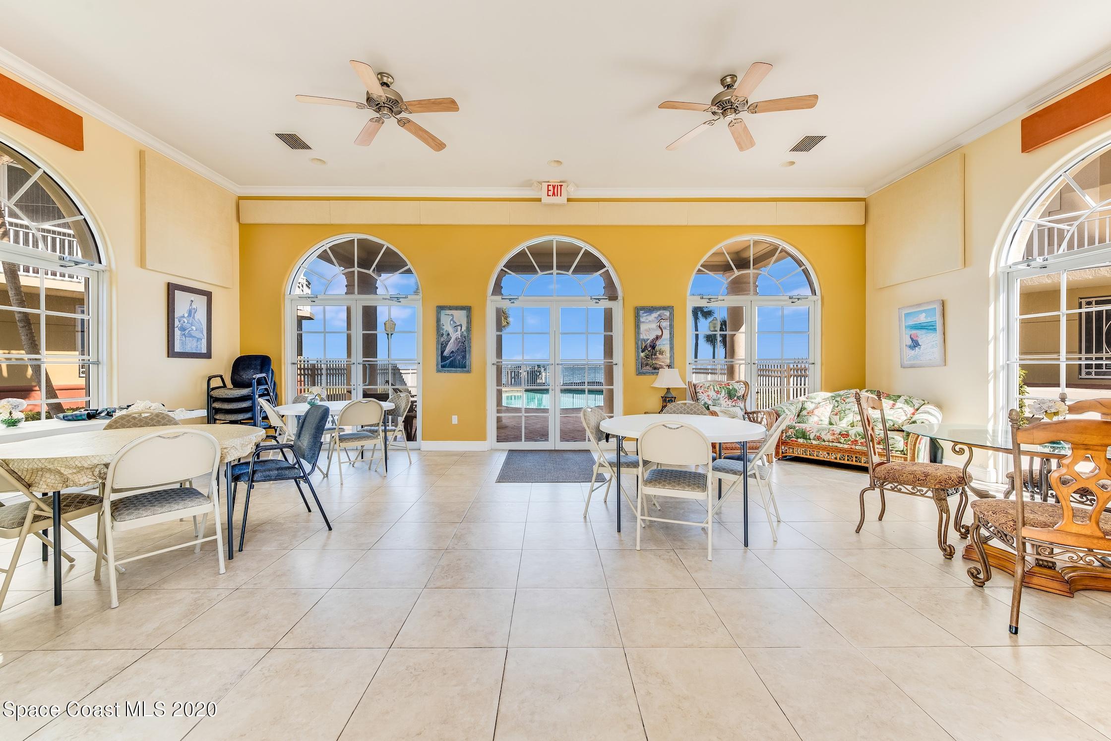 4955 Dixie Highway Northeast, Unit 404 Palm Bay, FL 32905 - Photo 35 of 50 a living room with furniture a chandelier and a large window
