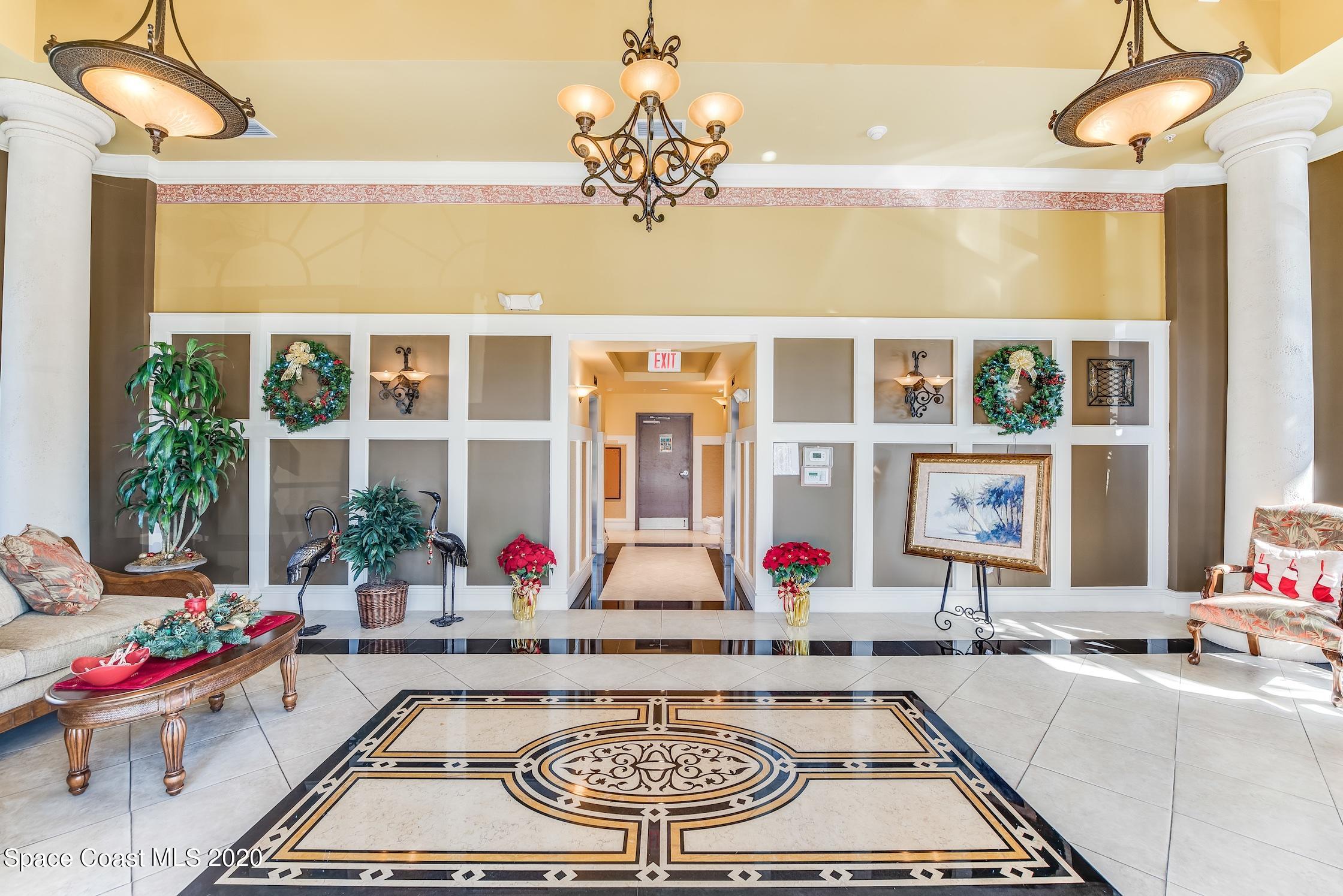 4955 Dixie Highway Northeast, Unit 404 Palm Bay, FL 32905 - Photo 37 of 50 a front view of a house with swimming pool and porch