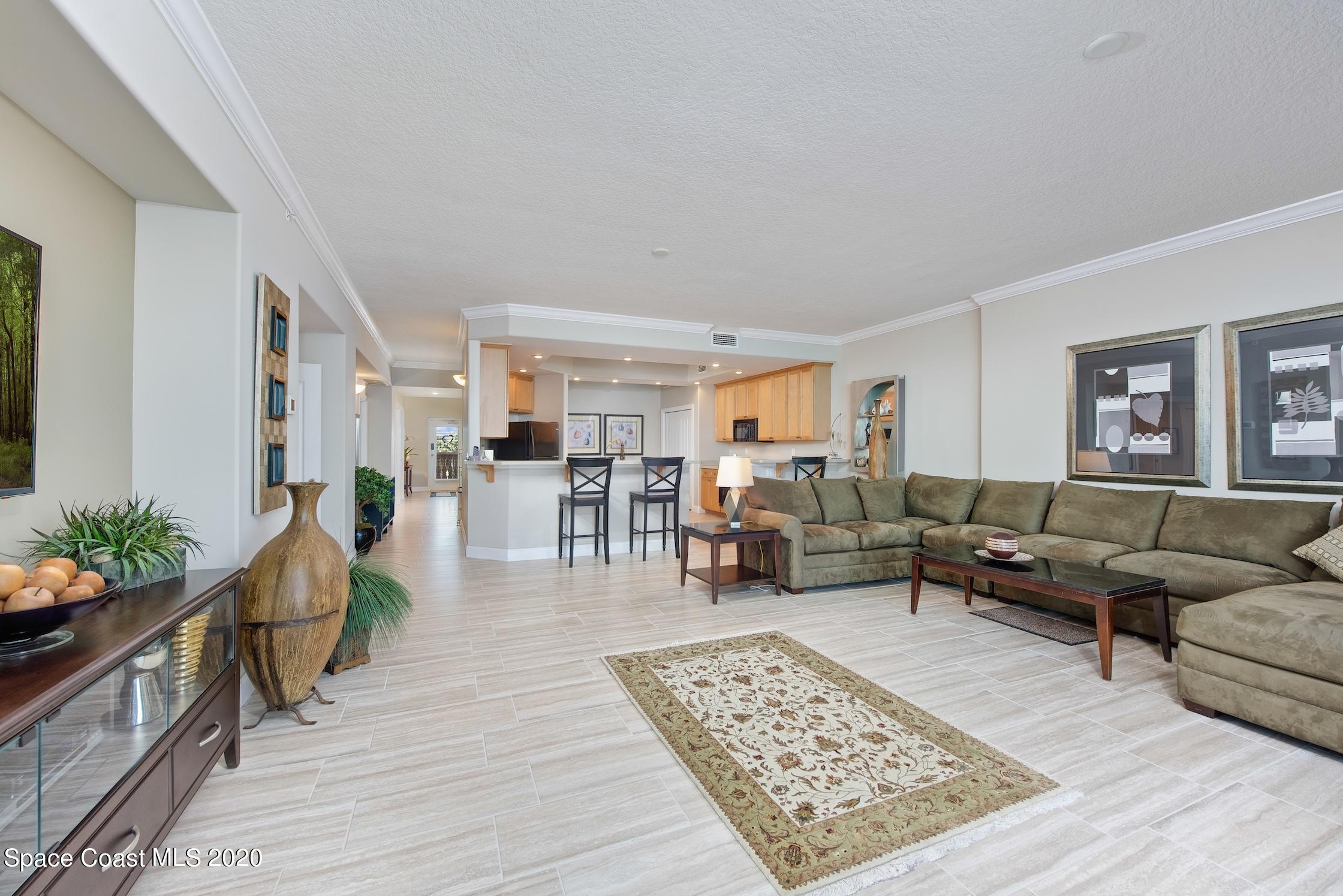 4955 Dixie Highway Northeast, Unit 404 Palm Bay, FL 32905 - Photo 7 of 50 a living room with furniture and wooden floor
