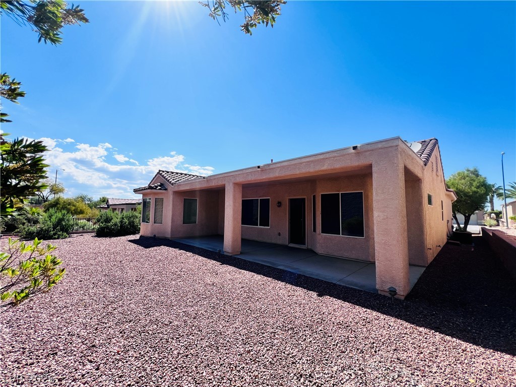 3047 Hickory Valley Road Henderson, NV 89052 - Photo 29 of 33 An inviting covered patio offers a cool retreat in a desert-landscaped backyard.