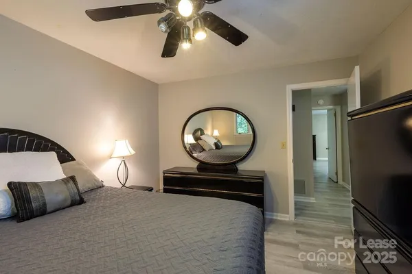 a bedroom with a bed and a chandelier