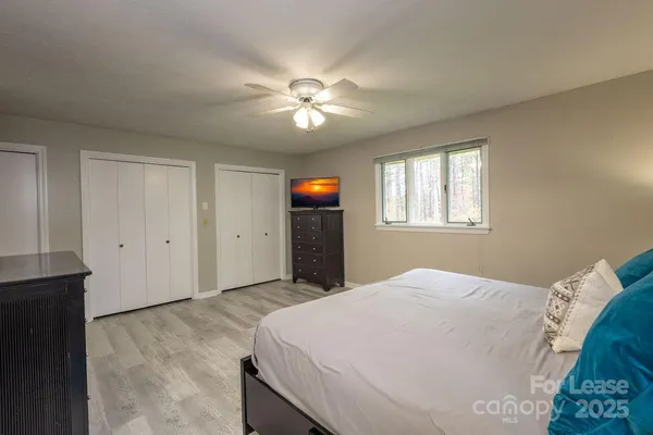 a bedroom with a large bed and a window