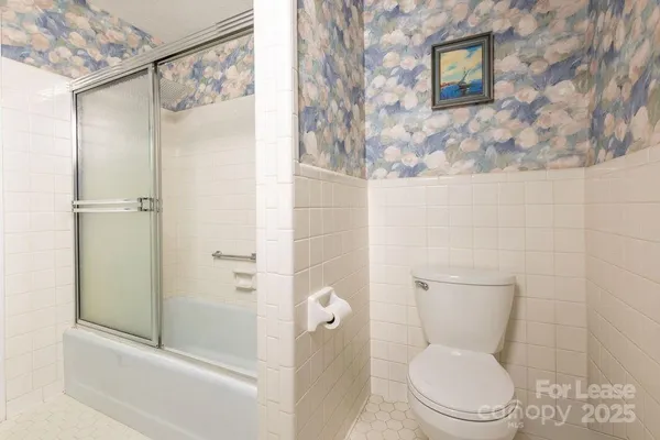 a white toilet sitting next to a bathroom sink
