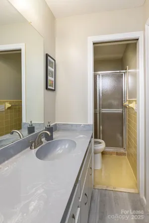 a bathroom with a granite countertop sink and a mirror