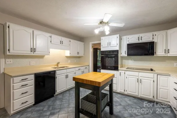 a kitchen with a sink stove and microwave