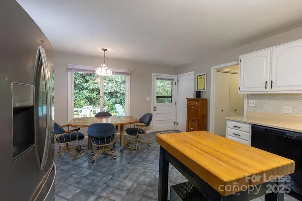 a room with chairs furniture and window