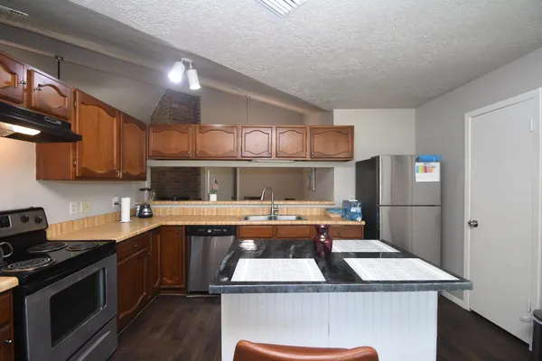 a kitchen with a sink a stove and refrigerator
