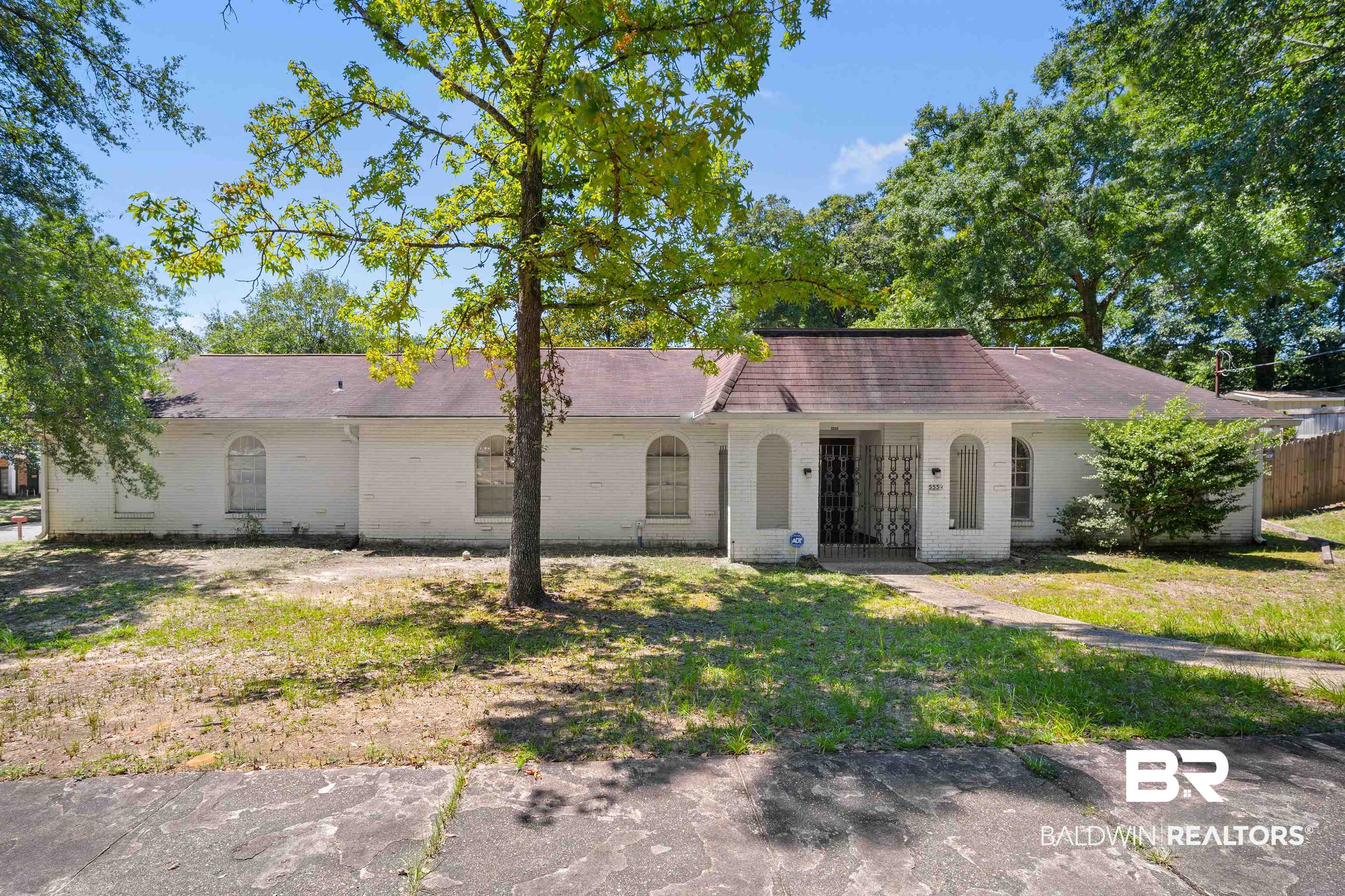 5559 Woodside Drive North Mobile, AL 36608 - Photo 1 of 28 Ranch-style home featuring brick siding, a front lawn, and roof with shingles