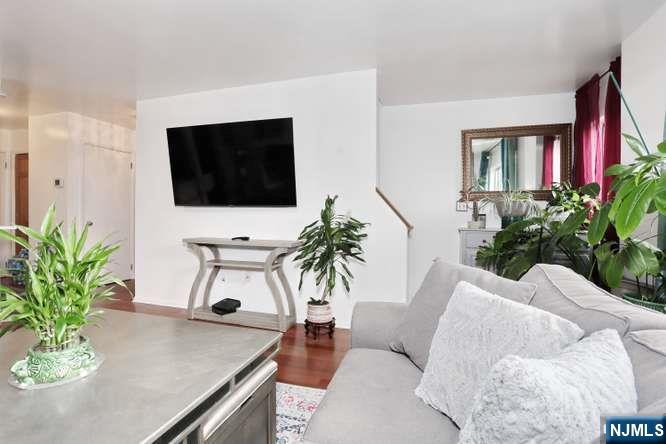 290 Hamilton Place, Unit 4 Hackensack, NJ 07601 - Photo 8 of 50 a living room with furniture and a flat screen tv