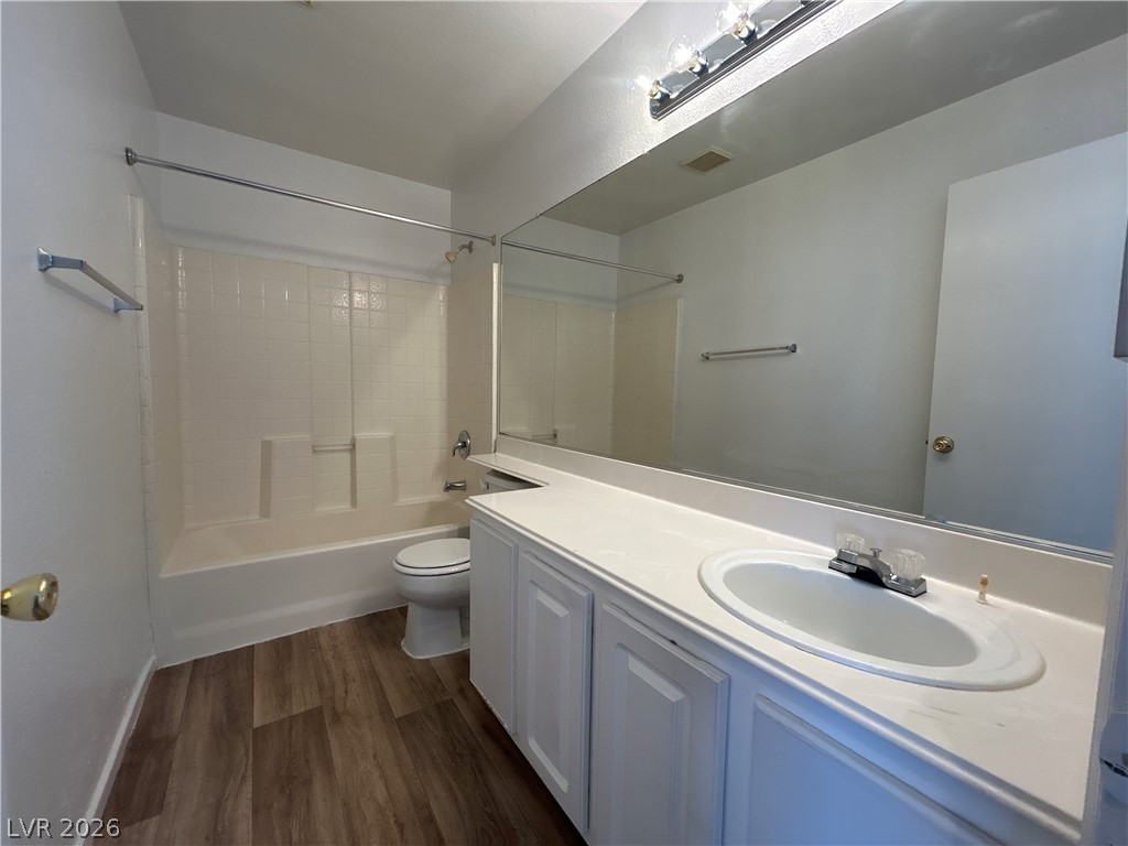 7373 Randel Jean Way Las Vegas, NV 89113 - Photo 13 of 14 Clean lines and wood-look flooring define this classic full bathroom setup.