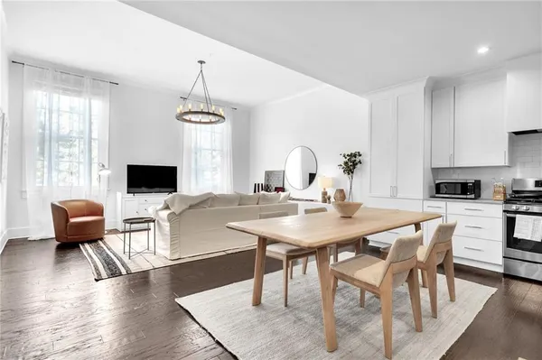 a view of a dining room with furniture window and wooden floor