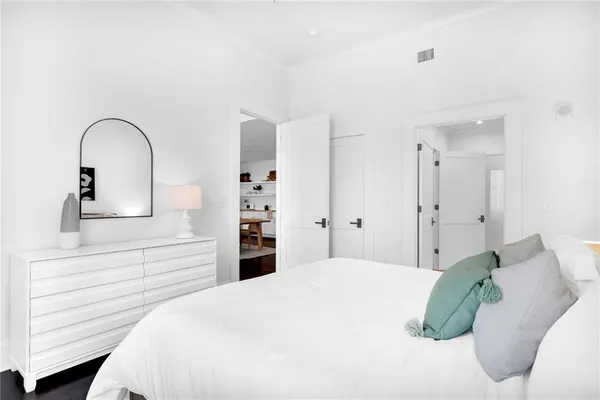 a bedroom with a bed and a dresser