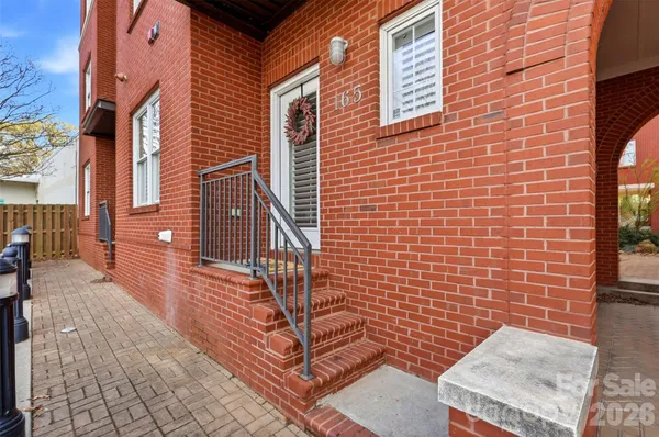 a view of a brick building with many windows