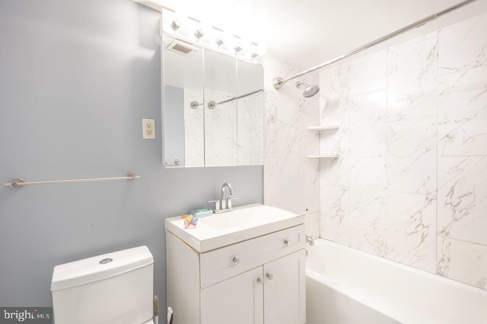 7549 Spring Lake Drive, Unit D2 Bethesda, MD 20817 - Photo 12 of 14 a bathroom with a sink a toilet and shower