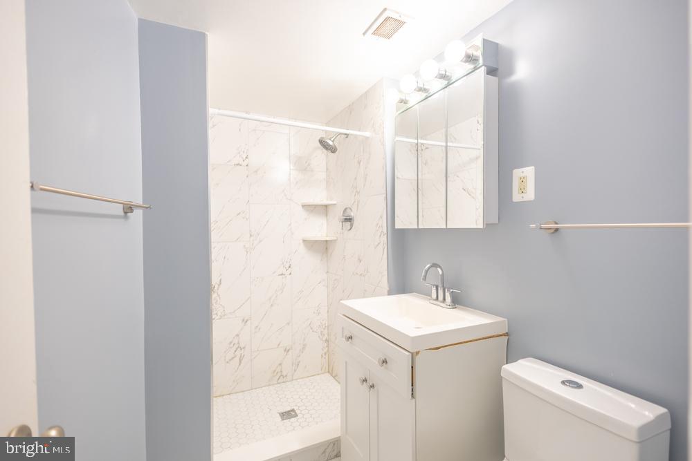 7549 Spring Lake Drive, Unit D2 Bethesda, MD 20817 - Photo 13 of 14 a bathroom with a sink a toilet and shower