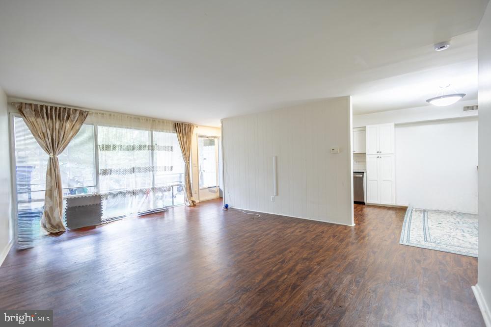 7549 Spring Lake Drive, Unit D2 Bethesda, MD 20817 - Photo 2 of 14 wooden floor in an empty room with a window