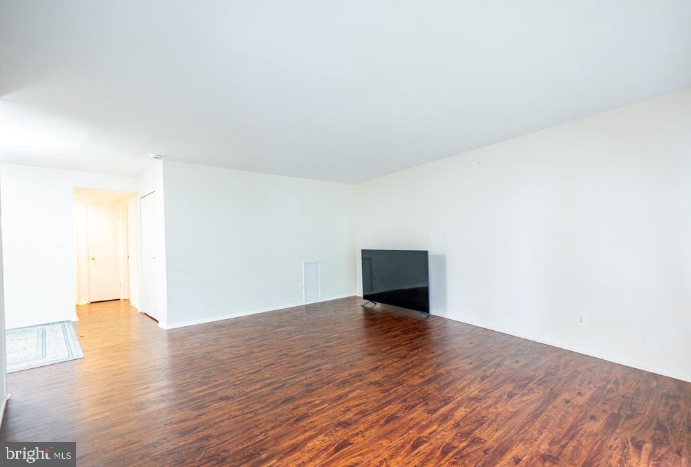 7549 Spring Lake Drive, Unit D2 Bethesda, MD 20817 - Photo 6 of 14 a view of an empty room and wooden floor