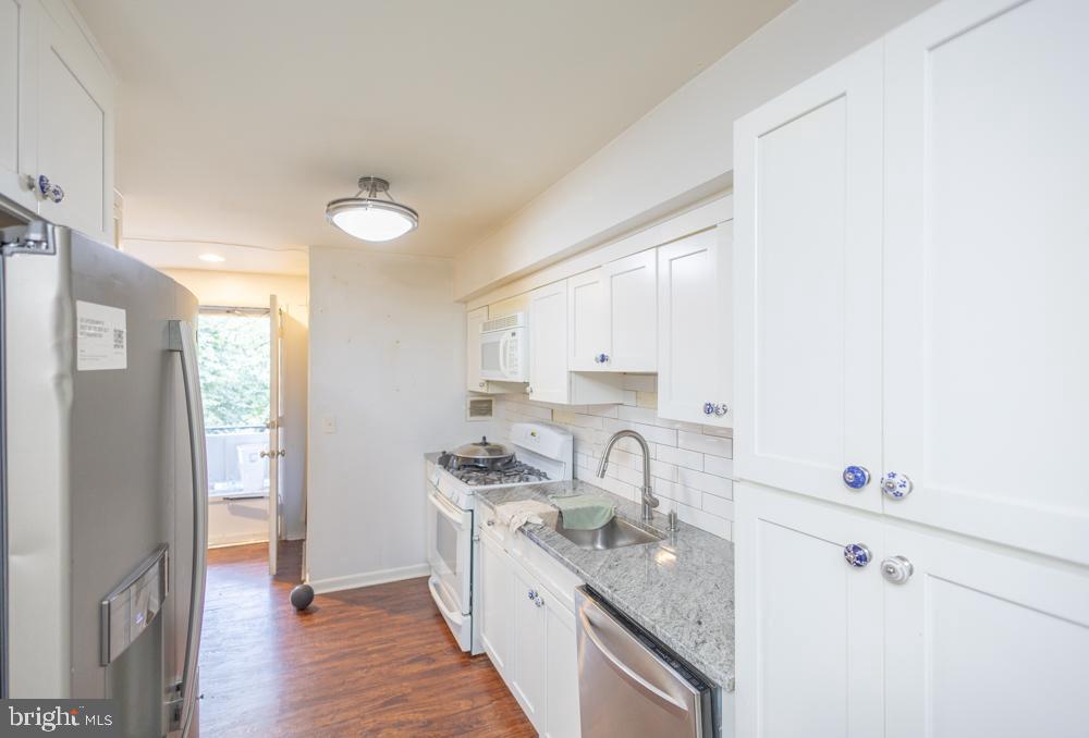 7549 Spring Lake Drive, Unit D2 Bethesda, MD 20817 - Photo 10 of 14 a kitchen with a sink a refrigerator and cabinets