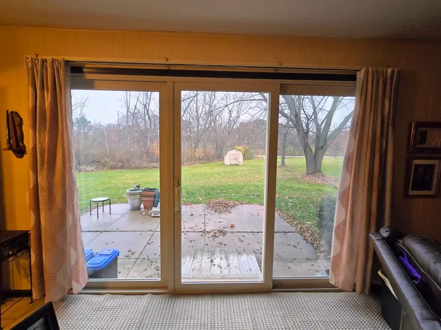 a view of an empty room with furniture and a fireplace