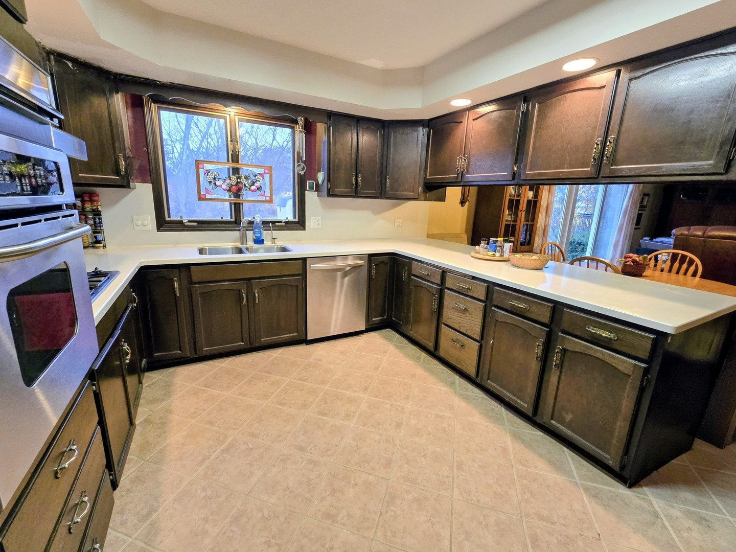 24656 South Willow Brook Trail Crete, IL 60417 - Photo 11 of 39 a kitchen with stainless steel appliances granite countertop a sink wooden cabinets dining table and chairs
