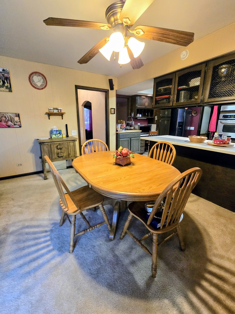 24656 South Willow Brook Trail Crete, IL 60417 - Photo 18 of 39 a dining room with furniture and a flat screen tv