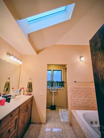 a bath tub sitting in a bathroom next to a sink