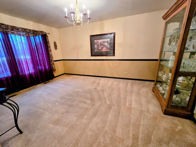 a living room with furniture fireplace and a large window
