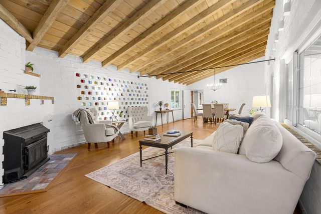 a view of a hallway with workspace and a window