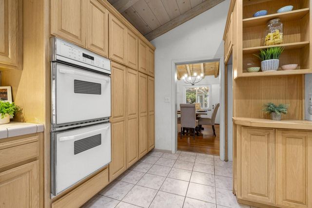 a bedroom with a bed and chandelier