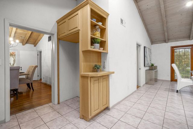 a spacious bedroom with a bed and a chandelier